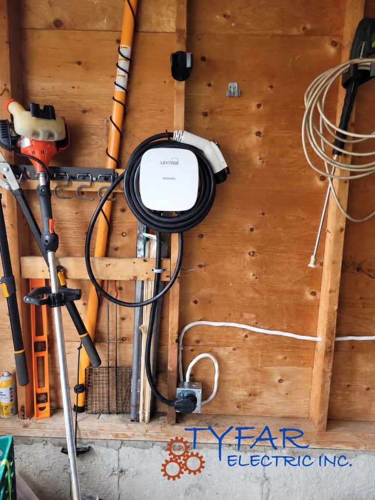 Leviton Level 2 EV charger installed in a residential garage with a NEMA 14-50 receptacle for electric vehicle charging in Ottawa.