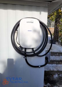 Clean, weather-rated EV charger installation for safe and reliable home charging. Residential EV charger installed on exterior wall in Ottawa by TYFAR Electric Inc.