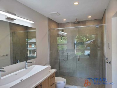 Bright, moisture-rated lighting for a clean, modern bathroom. Bathroom lighting and vanity electrical installation in Ottawa residence