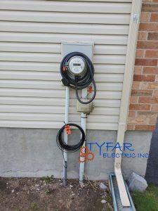 Utility-approved GenerLink installation for fast and safe backup power. GenerLink transfer switch mounted on exterior electrical service in Ottawa home