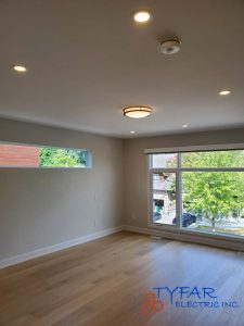 Clean, evenly spaced recessed lighting for modern living spaces. Recessed ceiling lights installed in residential room by TYFAR