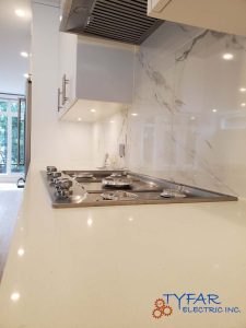 Targeted task lighting for safer, more functional kitchen workspaces. Kitchen task lighting installed over cooktop and countertops in Ottawa home